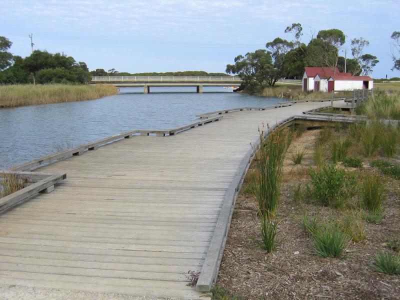 Anglesea - Anglesea River through the town and surroundings: View south along Anglesea River towards boat houses on River Reserve Road at Noble St