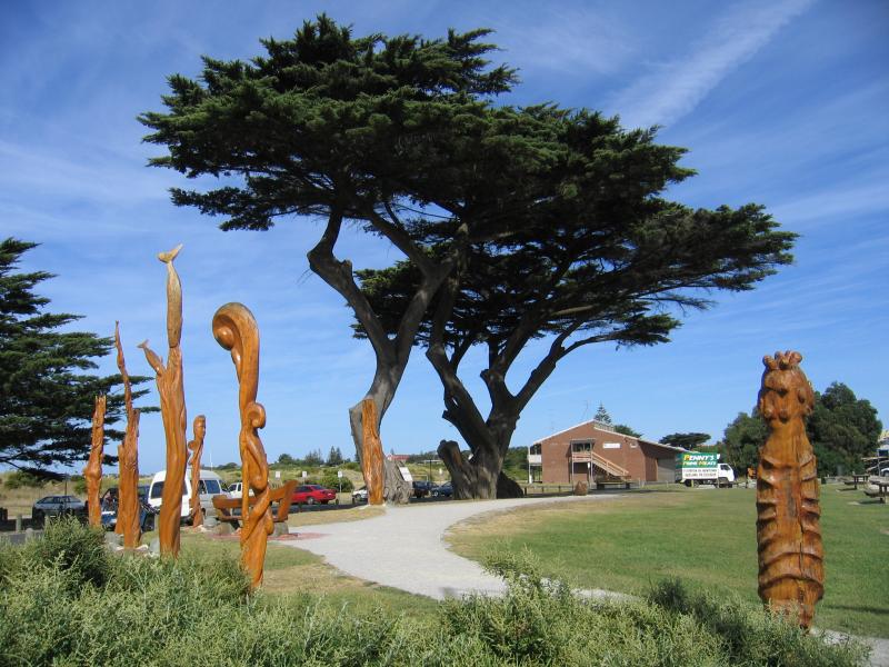 Apollo Bay - Foreshore Reserve in town centre, Great Ocean Road: Wood sculptures, view south along foreshore at Visitor Information Centre