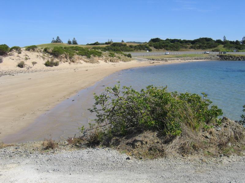 Apollo Bay - Boat Harbour, wharf and breakwater: View west along beach at breakwater