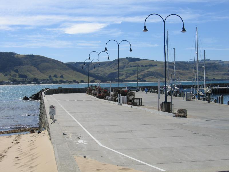 Apollo Bay - Boat Harbour, wharf and breakwater: View north along wharf from the beach