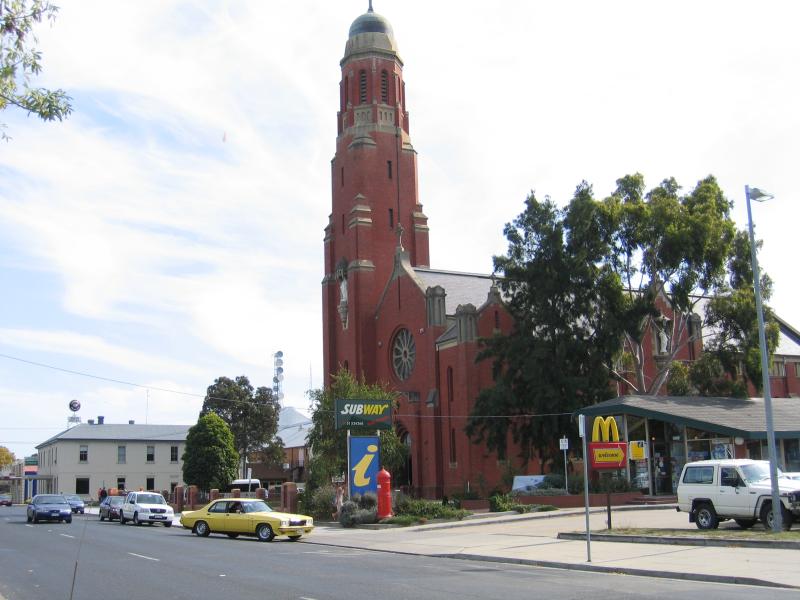 Bairnsdale - Commercial centre and shops: Visitor Information Centre and St Marys Cathedral, view west along Main St towards Pyke St