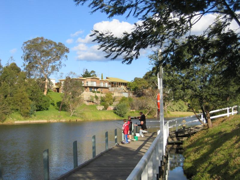 Bairnsdale - Mitchell River, just south of Princes Highway: People fishing off the wharf, view south along Mitchell River, Paynesville Rd