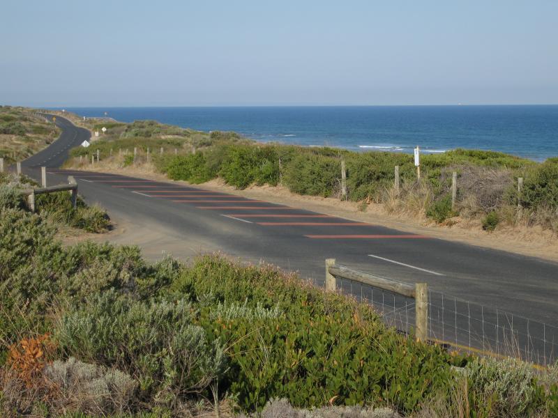 Barwon Heads - Thirteenth Beach fronting Bass Strait: View east along 13th Beach Rd at SLSC