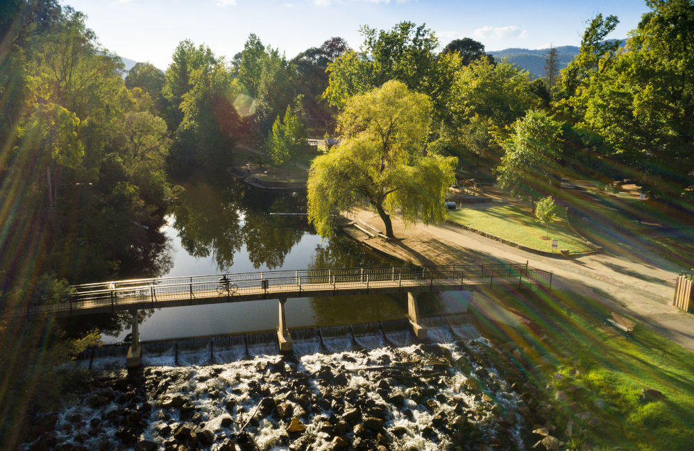 Bright - Aerial view of footbridge across Ovens River in Centenary Park
