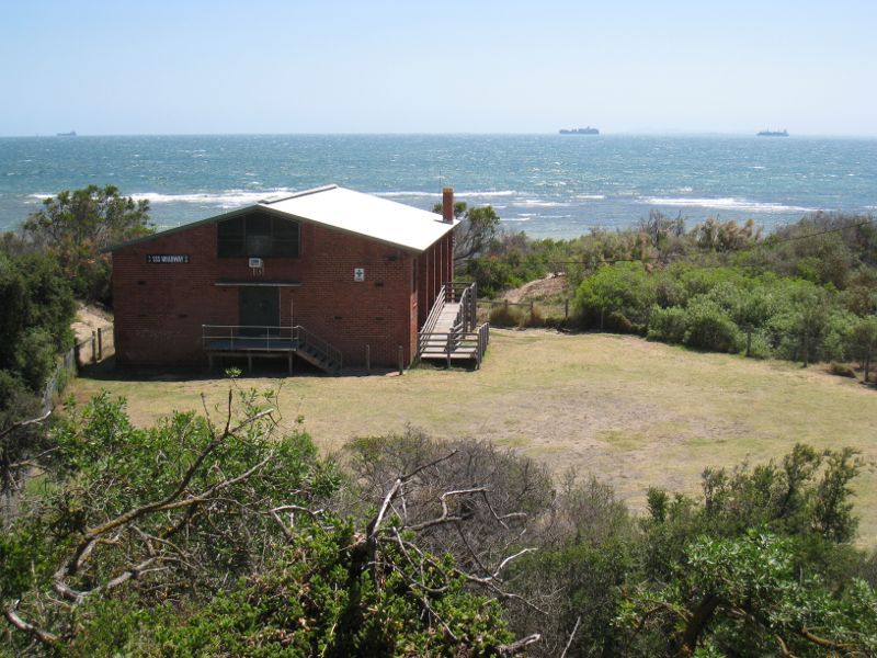 Brighton - Beach and coastline at Holloway Bend: View through Jim Willis Reserve towards scout hall and bay
