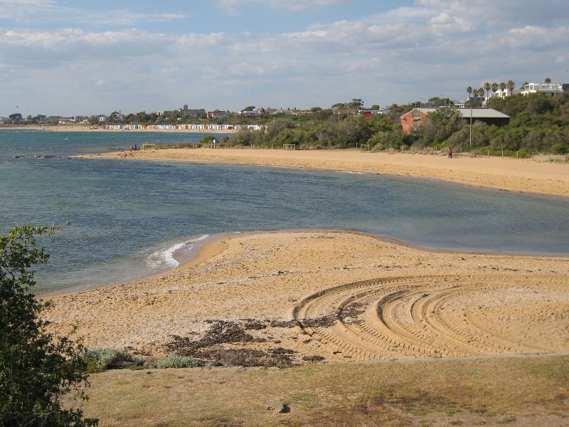 Brighton - Beach and coastline at Holloway Bend: Northerly view across beach towards bathing boxes at Dendy Street Beach