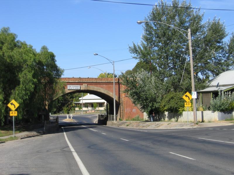 Castlemaine - Around Castlemaine and outskirts: View east along Midland Hwy towards railway bridge at Rowe St
