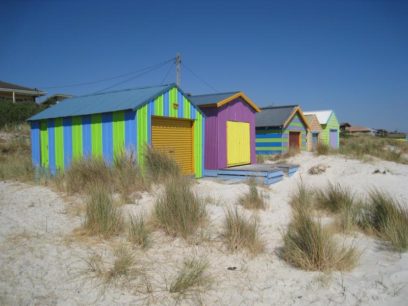 Chelsea - Beach and foreshore south of pier: Colourful bathing boxes on beach