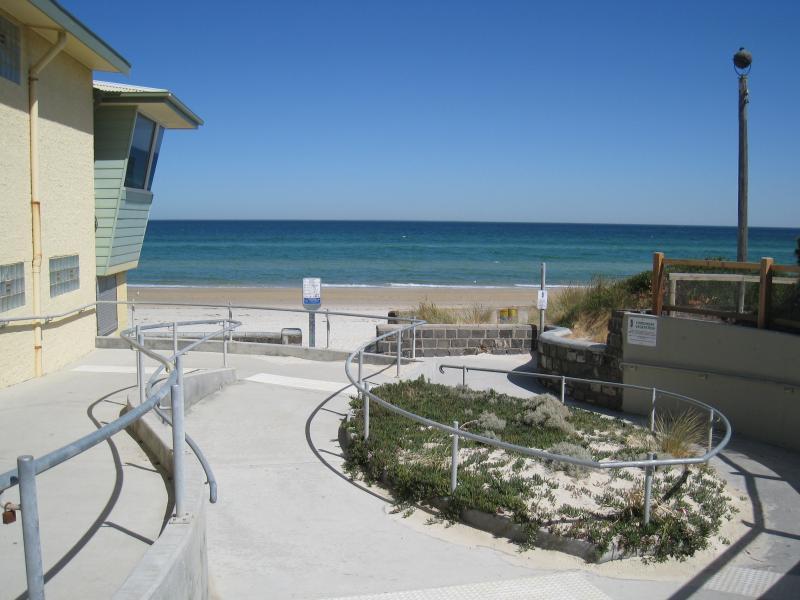 Chelsea - Beach and foreshore around pier and north of pier: View towards beach at surf life saving club at the end of The Strand