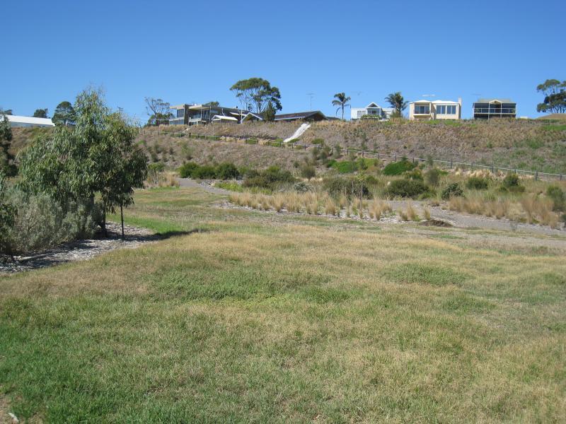 Clifton Springs - Parkland along coast, eastern side of Clifton Springs Boat Harbour: View south towards harbour access road and houses backing onto Adrian Mannix Reserve
