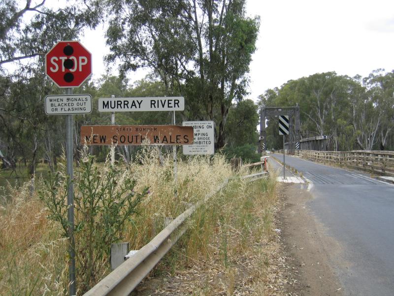 Cobram - Bridge across Murray River and surroundings: View east along Mookarii St towards bridge and welcome to New South Wales state border sign