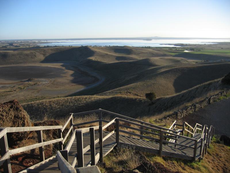 Colac - Red Rock main lookout: View from lookout down steps to car park with Lake Corangamite in background