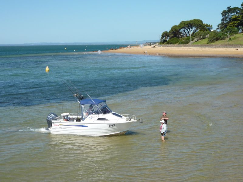 Cowes - Coast between Cowes Jetty and Erehwon Point: Boat on the water with Erehwon Point in background