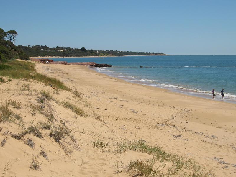 Cowes - Red Rocks and Penguin Point at end of Red Rocks Road: View south-west along beach towards Penguin Rock and McHaffie Point