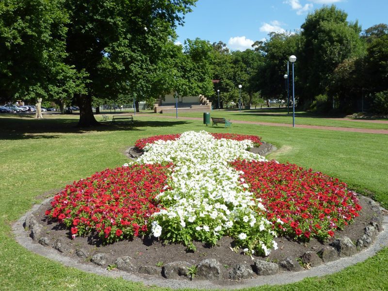 Dandenong - Dandenong Park, Foster Street and Pultney Street: View through park at flower bed towards soundshell
