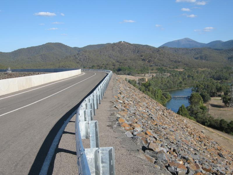 Eildon - Western end of dam wall on Lake Eildon: View south-east along road on top of dam wall
