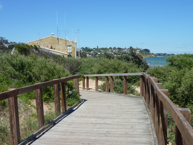 Frankston - Foreshore boardwalk and beach south of Frankston Pier: View along boardwalk between pier and coast guard