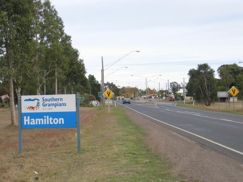 Hamilton - Around Hamilton: Hamilton town sign, view west along Glenelg Hwy towards Hamilton Hwy