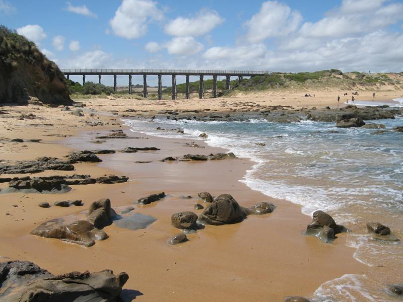 Kilcunda - Beach around Trestle Bridge: View back along beach at headland towards Trestle Bridge