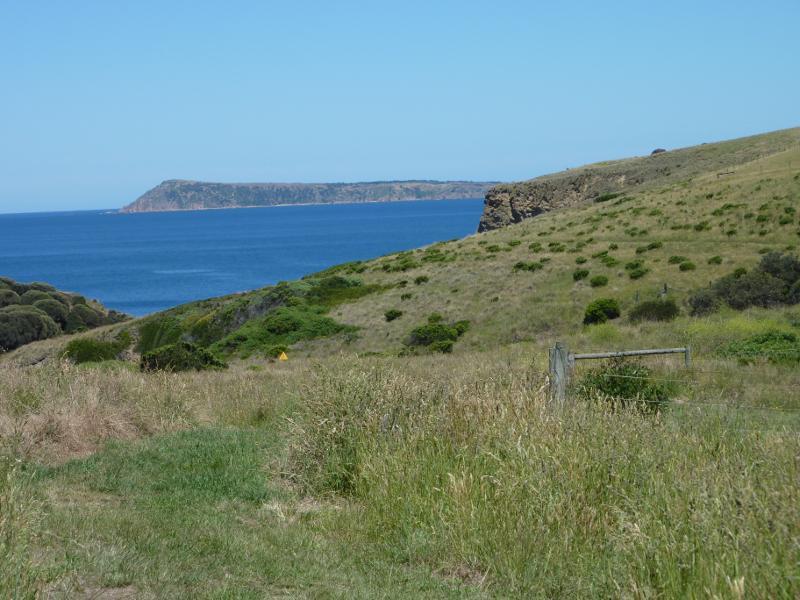 Kilcunda - Coastline along George Bass Coastal Walk at southern end of Mabilia Road: View west along coast towards Cape Woolamai from western end of Seaview St