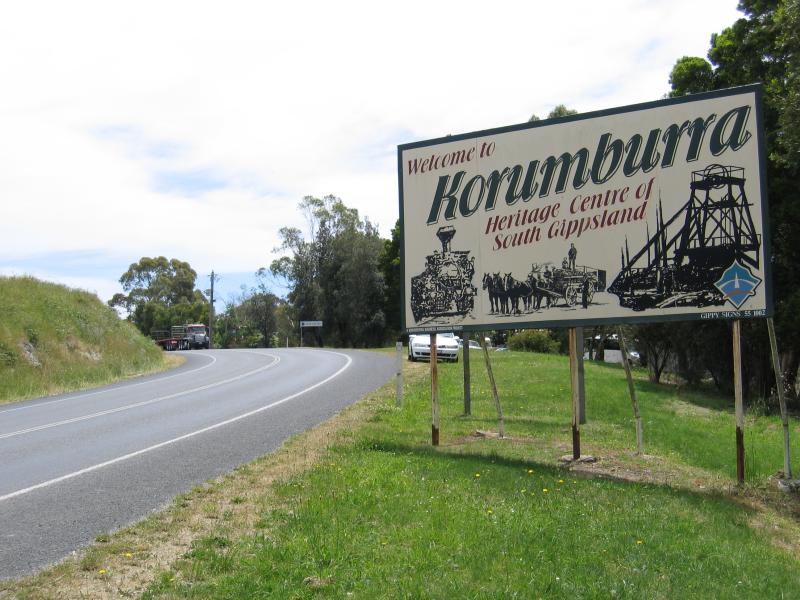 Korumburra - South Gippsland Highway through Korumburra - Welcome to Korumburra sign, view north along South Gippsland Highway at Coal Creek Heritage Park