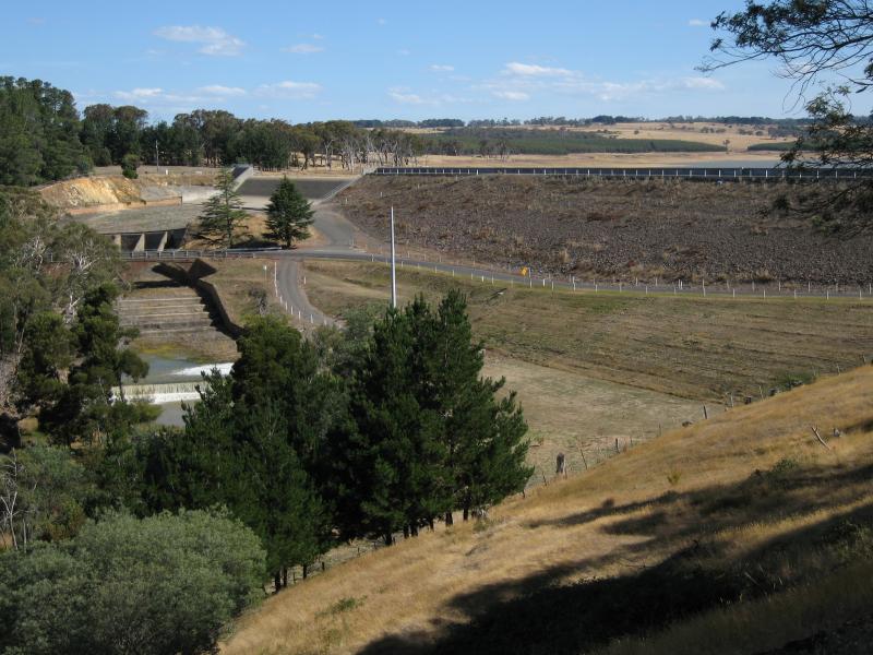Kyneton - Upper Coliban Reservoir: View south towards dam wall, spillway and Springhill Rd along base of dam wall