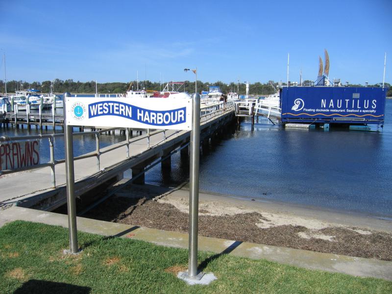 Lakes Entrance - Marinas, jetties and foreshore, Cunninghame Arm along Esplanade: Western Harbour and Nautilus floating dockside restaurant, opposite Carstairs Av
