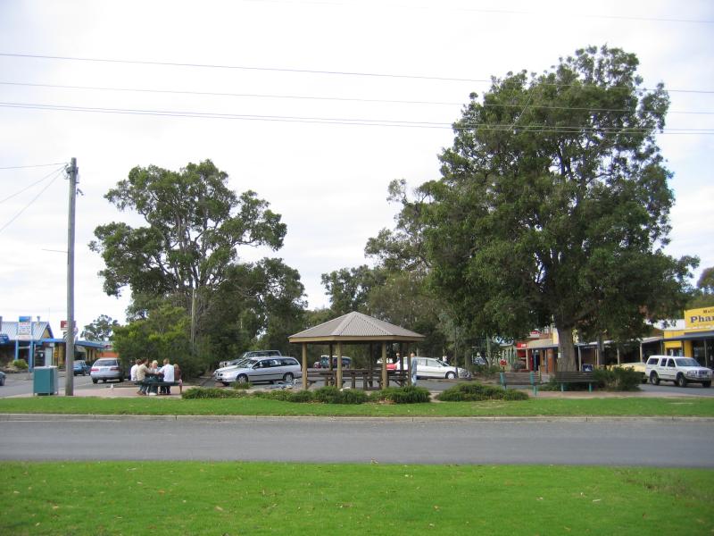 Mallacoota - Shops and commercial centre, Maurice Avenue: View north-east along Maurice Av at Betka Rd towards shops and car park in centre median