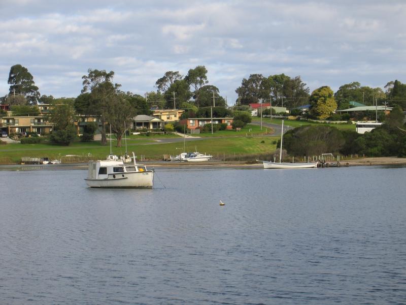 Mallacoota - Lakeside Drive and nearby residential areas: View east across inlet towards jetties on Buckland Dr from Lakeside Dr near Mirrabooka Rd