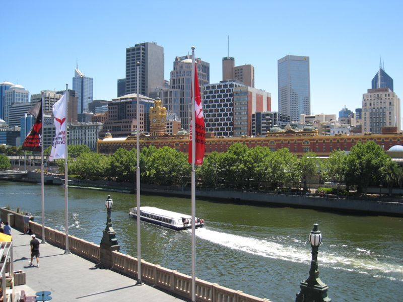Melbourne CBD - Yarra River at Flinders Walk: View from Southbank Promenade across Yarra River towards Flinders Street Station and city skyline