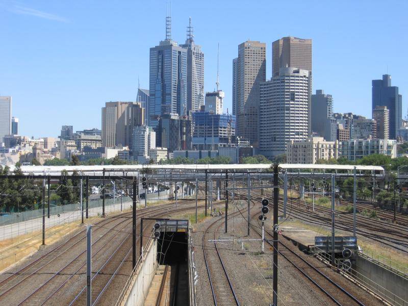 Melbourne CBD - Melbourne Park sporting venues, north side of Olympic Boulevard: View west along railway lines towards city skyline from footbridge to MCG
