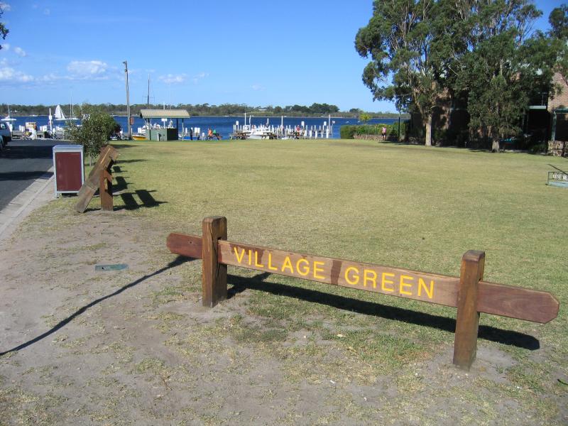 Metung - Commercial centre and shops, Metung Road: Village Green, view east along Kurnai Av towards wharf from Metung Rd