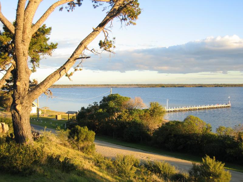 Metung - Beach and jetty, western end of Kurnai Avenue: View from southern end of Stirling Road, across Beach Rd towards jetty