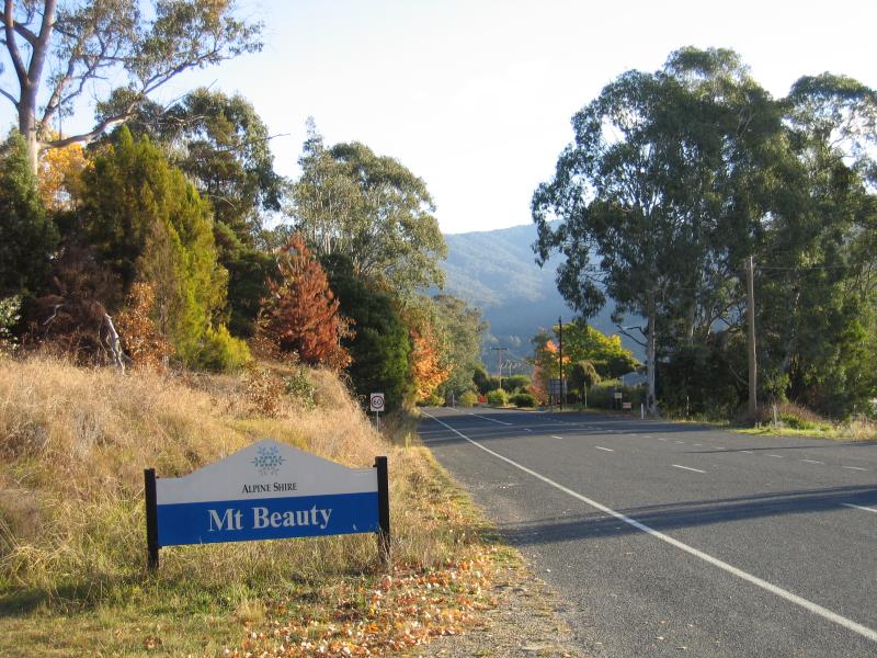 Mount Beauty - Bogong High Plains Road to Falls Creek: Town sign, view west along Bogong High Plains Rd near golf course