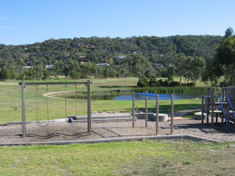 Mount Eliza - Mount Eliza Regional Park, Two Bays Road: View across playground and lake at Lakeside Picnic Area, towards residential areas in background hills