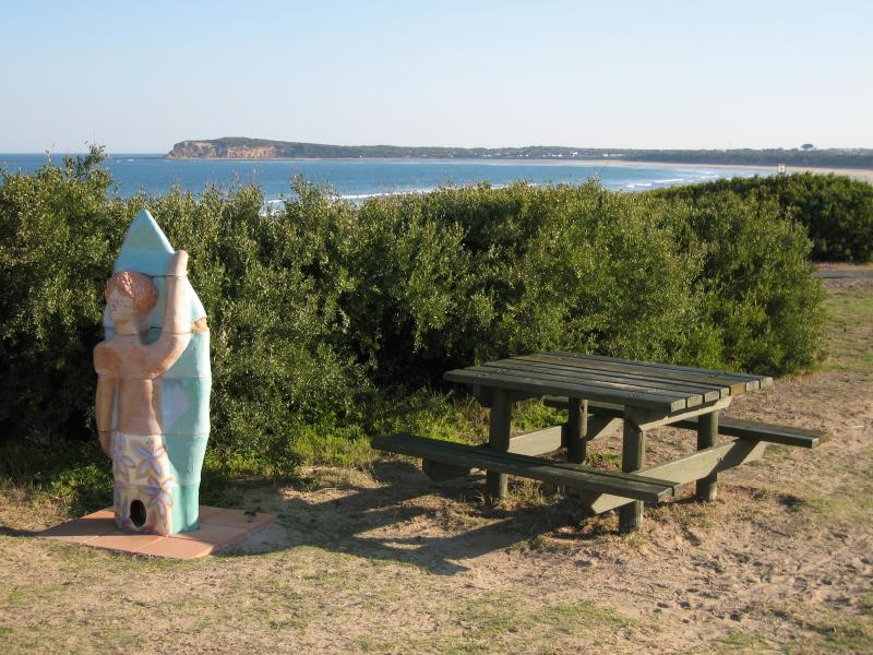 Ocean Grove - Surf Beach along Surf Beach Road and at Ocean Grove Surf Life Saving Club (SLSC): View south-west along foreshore towards The Bluff at Barwon Heads