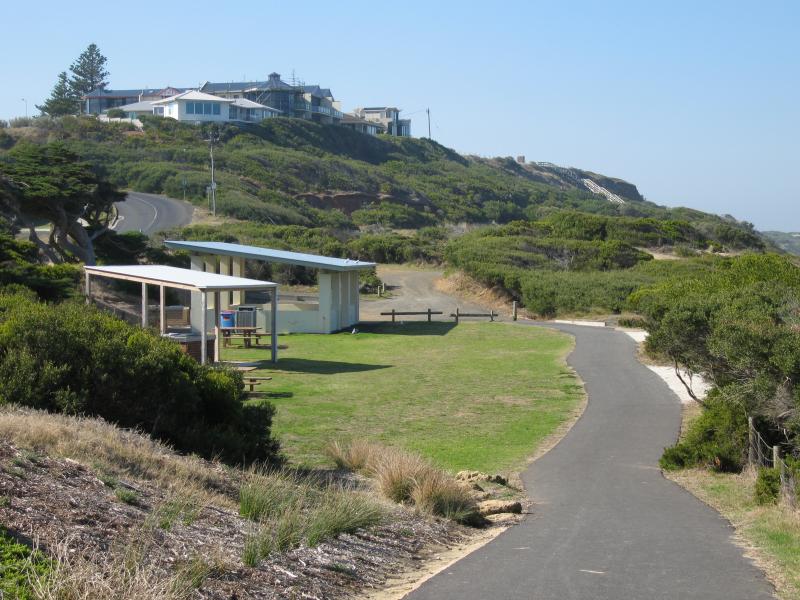 Ocean Grove - Surf Beach along Surf Beach Road and at Ocean Grove Surf Life Saving Club (SLSC): View east along foreshore path towards BBQ shelter at end of Presidents Av