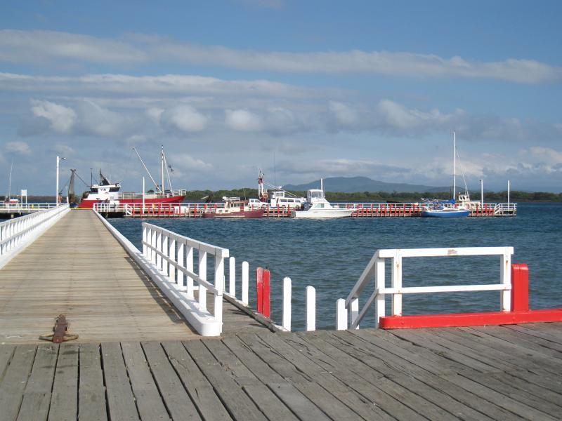 Port Welshpool - Port Welshpool Wharf and surrounding foreshore, Lewis Street near eastern end: View south along jetty at wharf