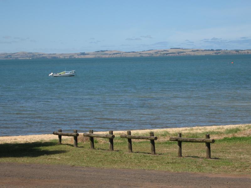 Rhyll - Shops and coast along Beach Road between Reid Street and boat ramp: View east across bay towards mainland from Beach Rd near Lock Rd