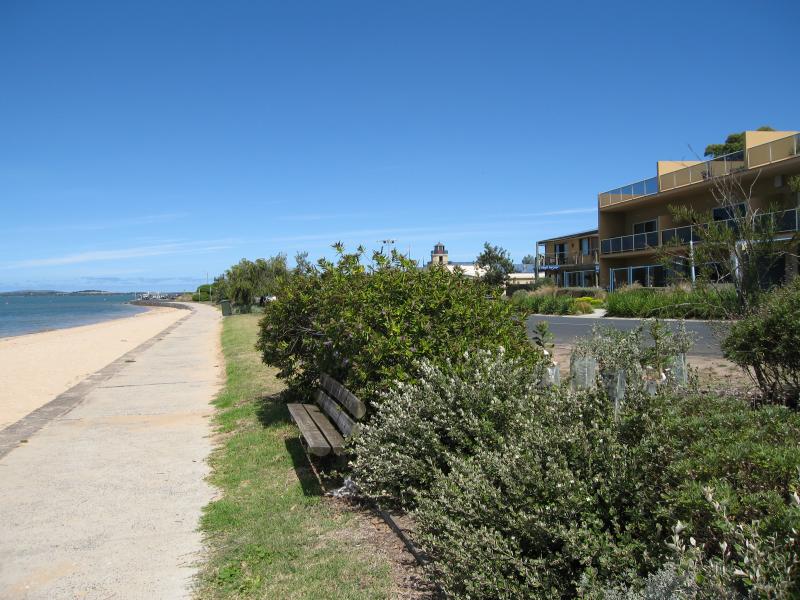 Rhyll - Shops and coast along Beach Road between Reid Street and boat ramp: View south along foreshore near Lock Rd