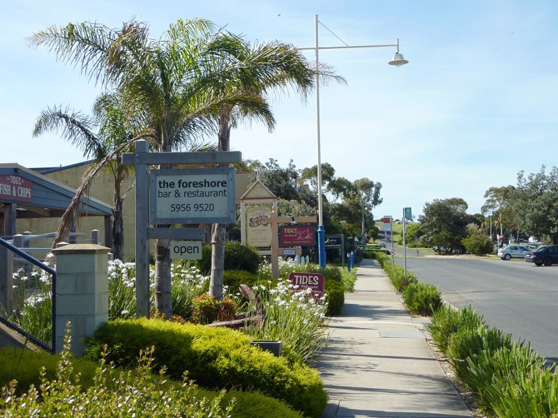 Rhyll - Shops and coast along Beach Road between Reid Street and boat ramp: Restaurants, view north along Beach Rd