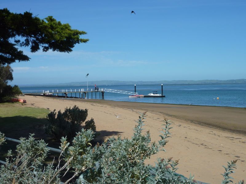 Rhyll - Boat ramp, Rhyll Jetty and coast along southern section of Beach Road - View east along coast towards boat ramp
