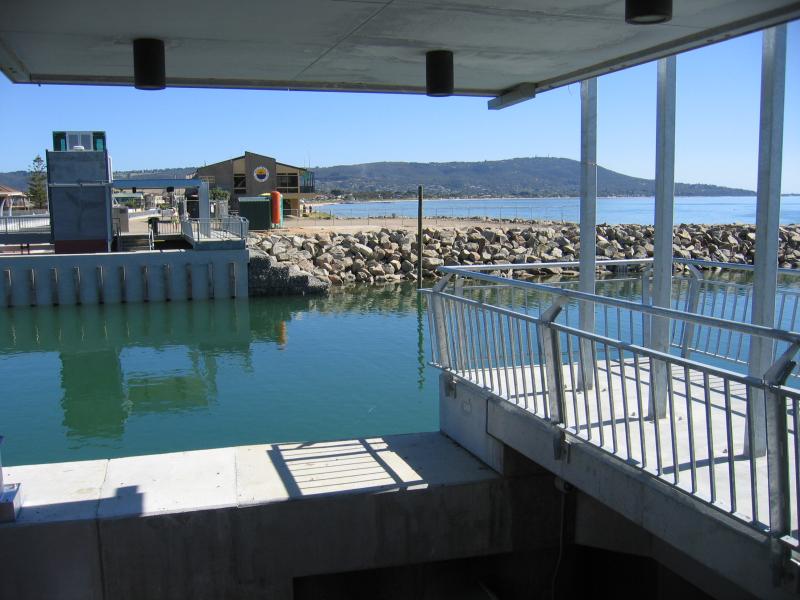 Safety Beach - Martha Cove canal entrance on coast and Marine Drive tunnel: View south across canal with Arthurs Seat in background