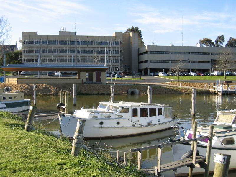 Sale - Port of Sale precinct, Canal Road and McMillan Street along Flooding Creek: View north across canal from southern bank towards Port of Sale Business Centre and Civic Centre