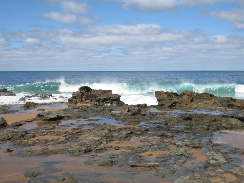 San Remo - Bore Beach, Potters Hill Road: View out to sea across rocks on beach