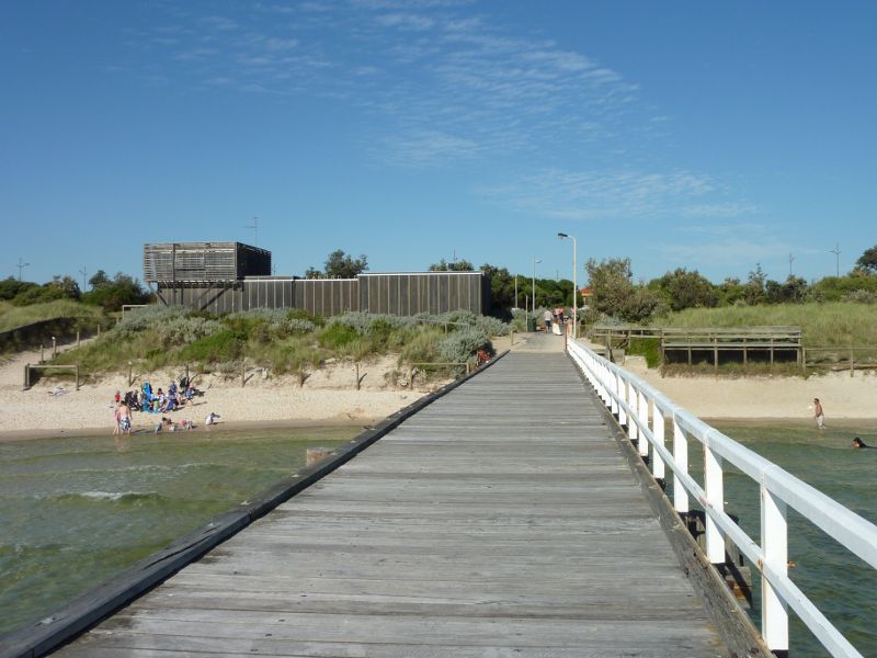 Seaford - Seaford Pier and surrounding beaches: View along pier towards Seaford Life Saving Club and the beach