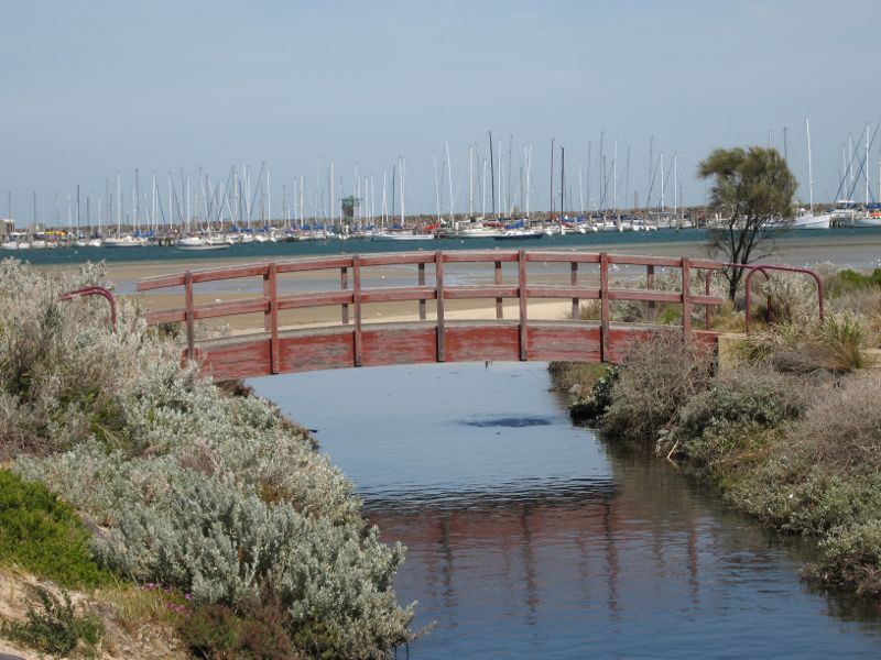 St Kilda - West Beach along Pier Road: Footbridge and St Kilda Harbour, viewed from northern end of Pier Rd