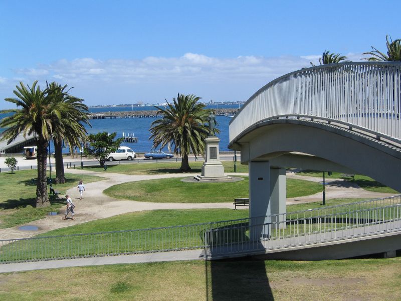 St Kilda - Gardens at southern end of Pier Road and at entrance to St Kilda Pier: View from footbridge across lawns towards harbour and pier