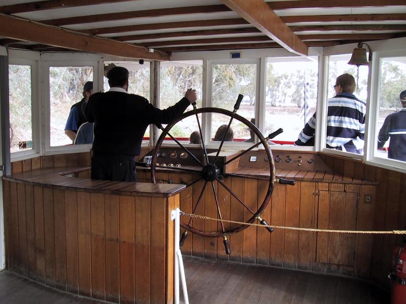 Swan Hill - Pioneer Settlement: The skipper guides the Pyap on its journey on the river