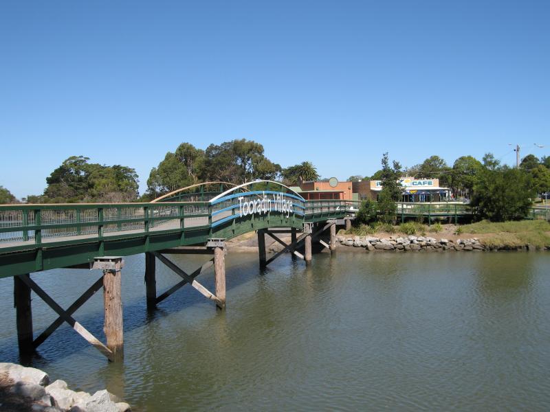 Tooradin - Sawtells Inlet north of South Gippsland Highway: View east across Sawtells Inlet towards footbridge and shops
